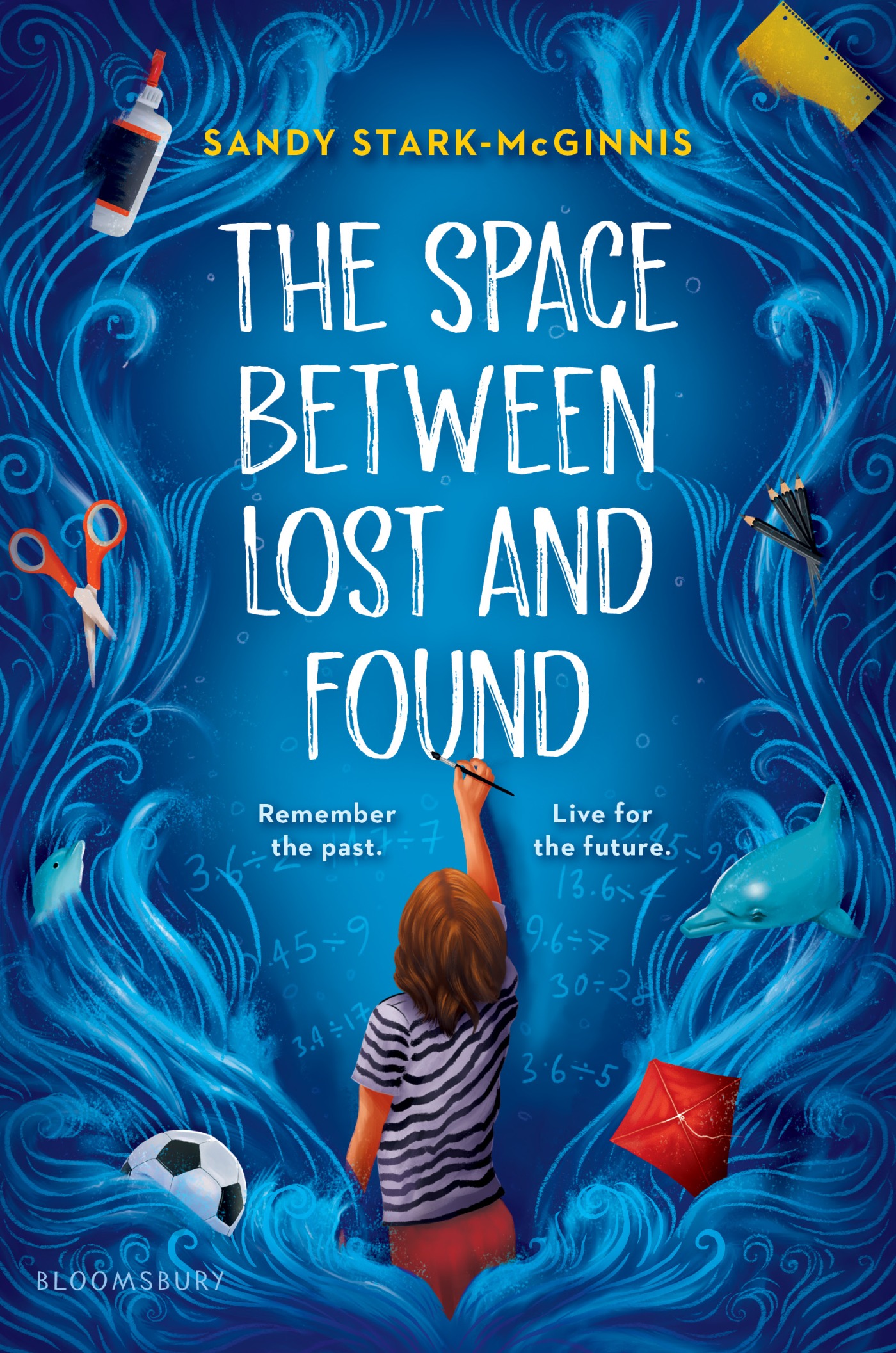 Front cover image of The Space Between Lost and Found of a person writing on the cover with scissors, paint, soccer ball, kite and dolphin in the blue waves surrounding the outside of the book